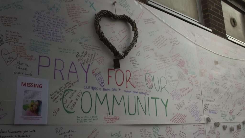 One of the local makeshift community walls around the Grenfell Tower fire site on which people posted their thoughts and condolences. Most prominent of all was daubed: "Pray for our community"