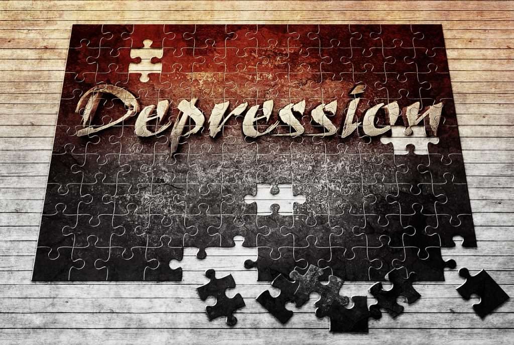 Large puzzle set on wooden flooring almost completed displaying the word Depression.