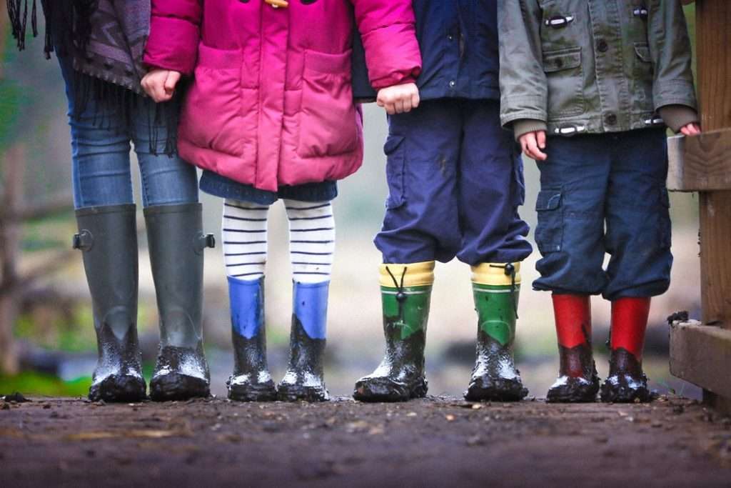 4 children in kids in rainwear and wellies